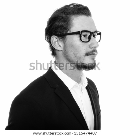 Close up profile view of young handsome businessman thinking with eyeglasses isolated against white background