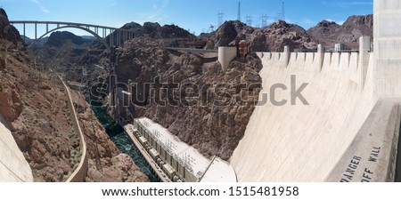 Looking down from Giant Hoover Dam  Powerplant Buildings, Colorado river and Mike O'Callaghan–Pat Tillman Memorial Bridge, sunny day