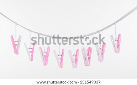 pink and white clothespins on isolated white background