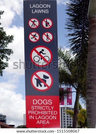 A sign in a park showing prohibited six items in a lagoon area        