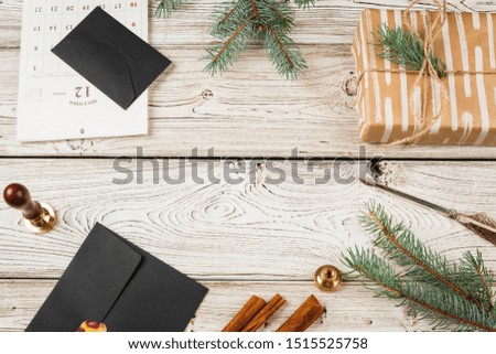 Writing Christmas post on holiday wooden decorated background 