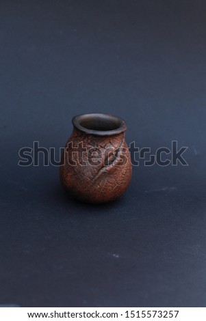 handmade red clay cup for yerba  tea on black back background, traditional yerba mate tea gourd, calabash, food and drink, ceremic texture, design