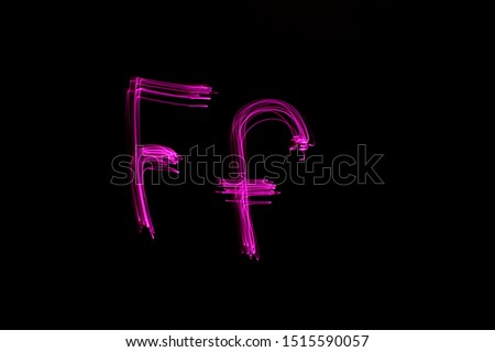 Long exposure photograph of the letter f in upper case and lower case, in pink neon colour in an abstract swirl, parallel lines pattern against a black background. Light painting photography.