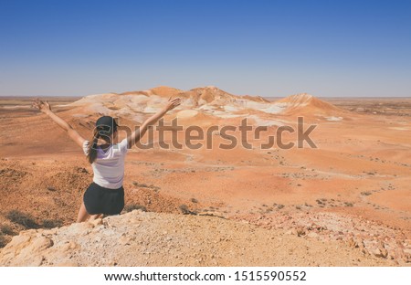 lonely woman in the desert Breakaways, situated in Central Australia near Coober Pedy, moon scenery of many movies