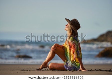 young woman relaxing on the beach in summer day