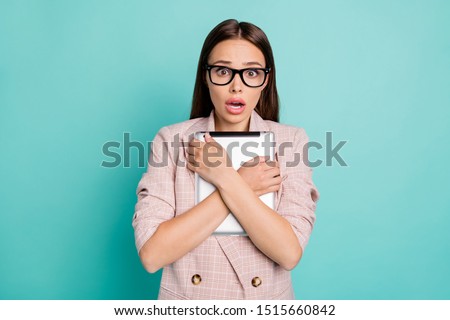 Close-up portrait of her she nice-looking attractive lovely winsome smart clever frightened straight-haired lady hugging ebook isolated over bright vivid shine blue green teal turquoise background