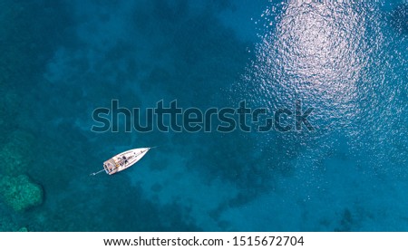 Aerial view on the boat in the blue sea. Vaction concept.