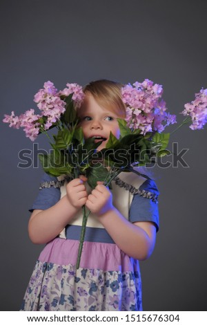 Little girl with a bouquet of lilac, mother's day