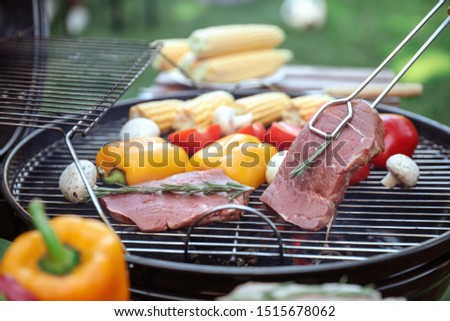Cooking fresh food on barbecue grill outdoors, closeup