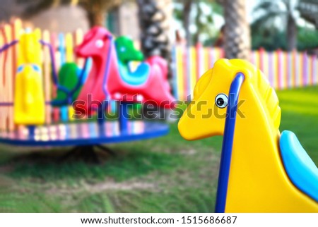 kids club or kinder garden horses carousel ride in colorful environment