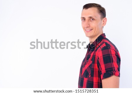 Closeup profile view of happy hipster man looking at camera