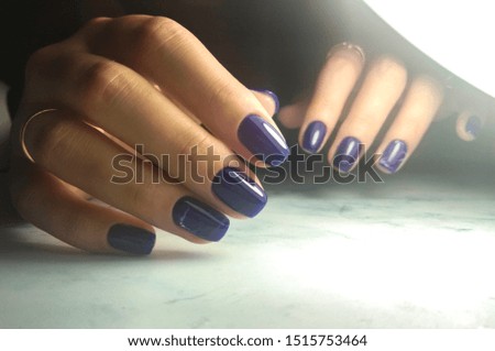Dark blue gel lacquer with marble design. Manicure with azure coating.