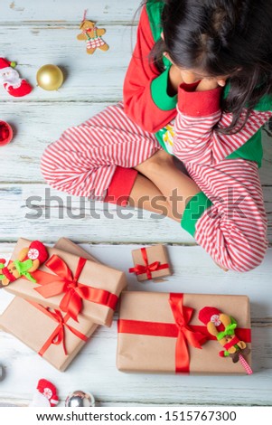 Cute brunette girl with her presents on Christmas day