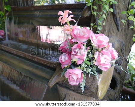 Colorful pink and white roses on the waterfall model.