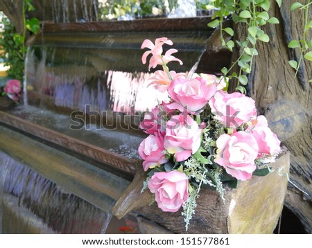 Colorful pink and white roses on the waterfall model.