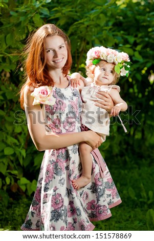 Beautiful Mom and baby outdoors. Happy family playing in nature. Mom and baby. Mother and child.