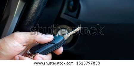 Closeup inside vehicle of hand holding key in ignition, start engine key. Royalty-Free Stock Photo #1515797858