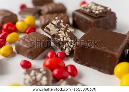 Assorted chocolate colored candies on a white background