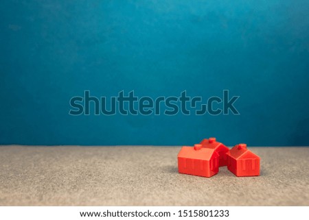 red miniature three houses. the concept of wealth, influence, environment, success