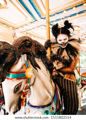 Hellga Scary Clown on Carousel Horse Medium Shot