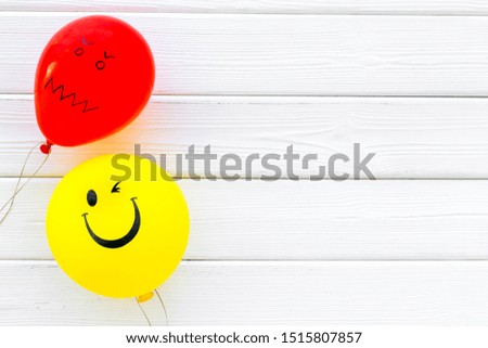 Treat depression concept. Balloons with frustrated and smiling faces on white wooden background top view space for text