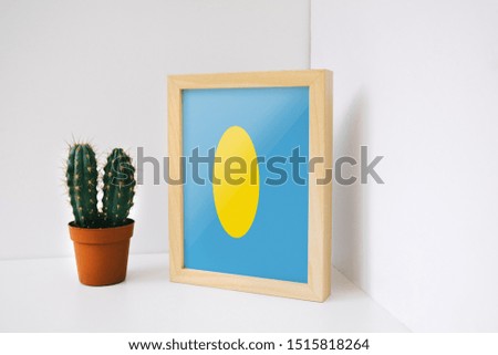 Flag of Palau on photo frame. Palau Flag in wooden frame.