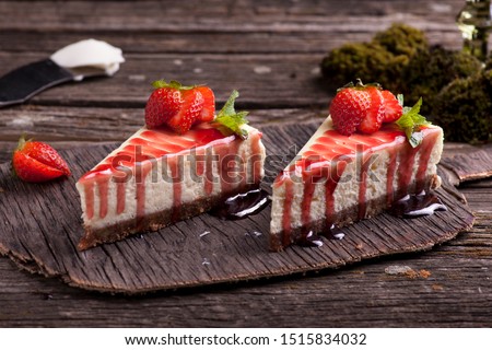 Strawberry cheesecake on wooden exposition  Royalty-Free Stock Photo #1515834032