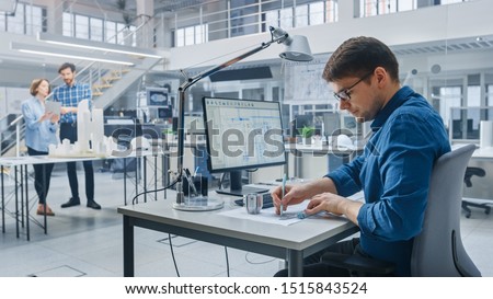 In Architectural Bureau: Team of Architects and Engineers Working on a Building Complex Prototype Project, Using City Model and Computers Running 3D CAD Software. Residential or Business District Royalty-Free Stock Photo #1515843524