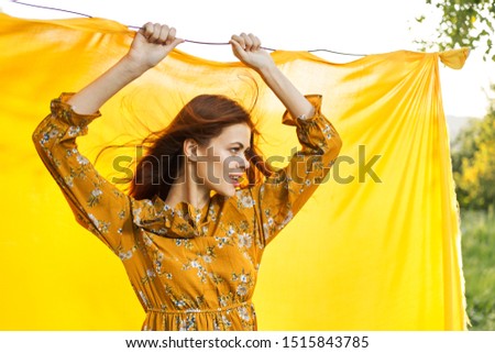 woman in summer yellow dress looks away