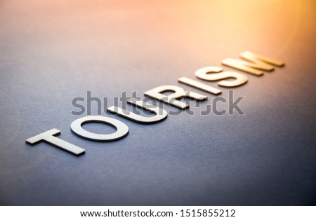 Word tourism written with white solid letters on a board