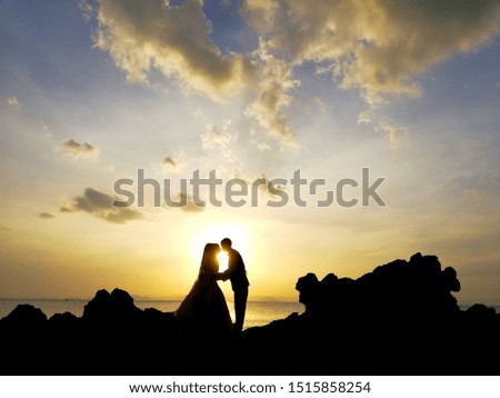 The shadow of a Muslim lover at a stone near the sea Sunset time,wedding sunset pictures