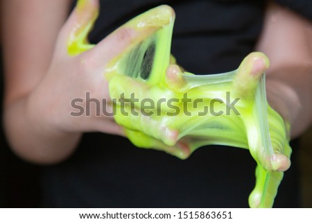 Kid Playing Handmade Toy Called Slime, Selective focus on Slime, Teenager having fun and being creative homemade slime