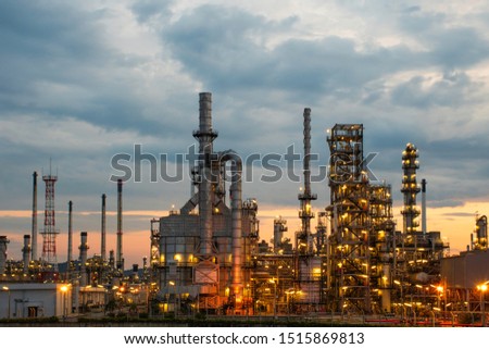 Morning sunrise view of the oil refinery and petrochemical plants, details of the steel pipe equipment with a blue background