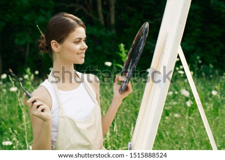 woman easel with bright colors on nature