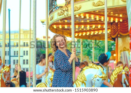 Young pretty woman closeup in different poses on the carousel background near Red square in Moscow.