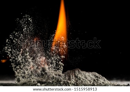 burning sand and a splash of water on a black background, the fifth element