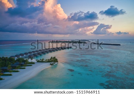 Aerial photography by Maldivian resorts in sunset.