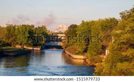 A river at sunrise with industry in the background