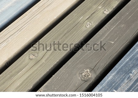 Diagonal view of wooden boards of dull colors olive, beige and blue texture, natural pattern. Exterior and interior design.