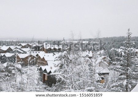 Panorama of a snowy ski village in northern Finland Levi ski resort with a cloudy sky.