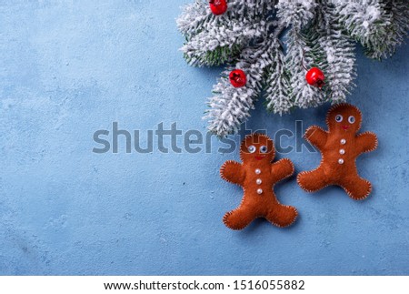 Christmas blue background with gingerbread men made of felt