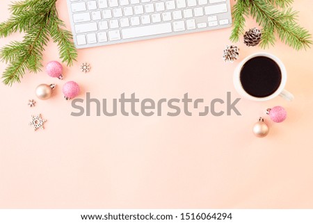 Flat lay christmas home office desk with spruce branches and keyboard, christmas decorations on a color background