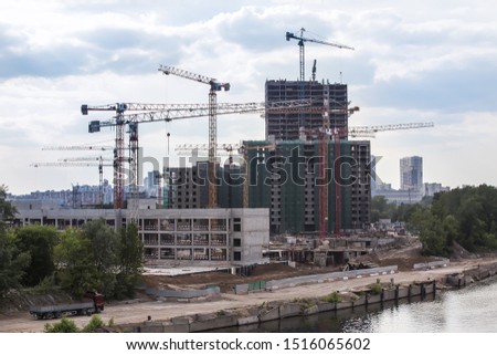 Residential buildings under construction on the river bank