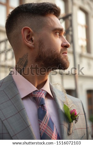 Caucasian romantic young groom celebrating marriage in city. Stylish man on modern city's street. Family, relation, love concept. Contemporary wedding. Feeling happy, important moments. Details.