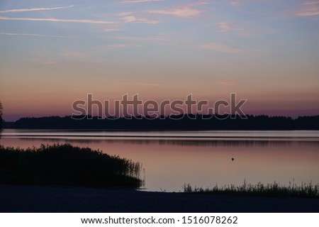 Beautiful sunny sunset over the lake. Evening landscape.