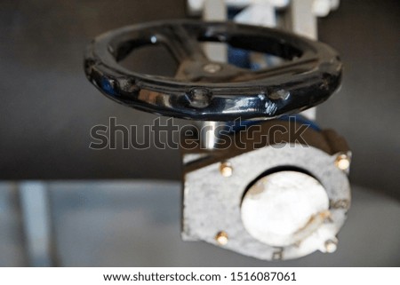 Close up black valve plug on plastic pipe