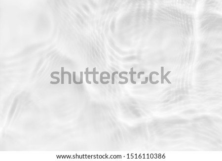 White texture of light-shadow pattern of sunlight reflection from rippled water surface. Beautiful natural pattern with 3D feeling. White-grey water waves marbling. Royalty-Free Stock Photo #1516110386