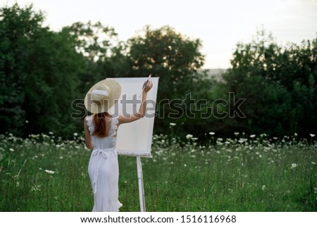 girl young woman artist paints an easel