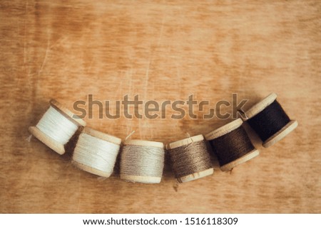 Set of threads on wooden background with copy space for your texture background with copy space for text