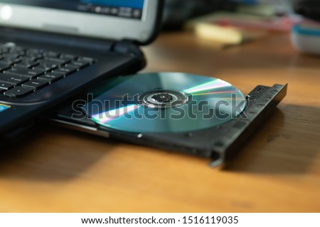 CD in the laptop cd/dvd drive Royalty-Free Stock Photo #1516119035